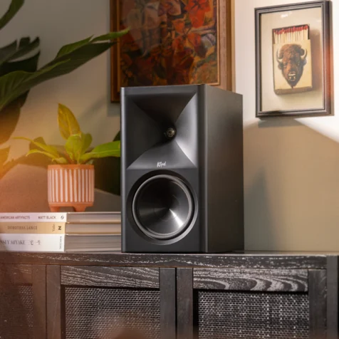 Klipsch-The-Sevens-BK-on-modern-media-console-beside-plant-and-Americana-art-with-warm-lighting2_2000x2000